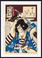 A framed Japanese ukiyo-e woodblock print featuring a samurai warrior in a blue and white kimono with a sword raised overhead, shown against a dark background with a white mat and black frame.