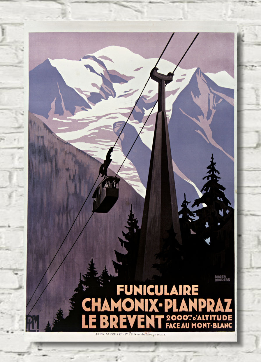A vintage-style travel poster for a funicular railway in the French Alps, featuring snow-covered mountains, evergreen trees, and a cable car, displayed on a white brick wall.