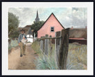 A framed art print featuring a landscape painting of a man walking along a dirt path towards a pink house and church steeple under a cloudy sky.