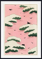 A framed art print featuring a Japanese-style design with a pink sky, cream and green clouds, and black birds, presented in a black frame with a white mat.