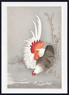A framed Japanese-style art print depicting a rooster and hen near bamboo, with a white mat and black frame.