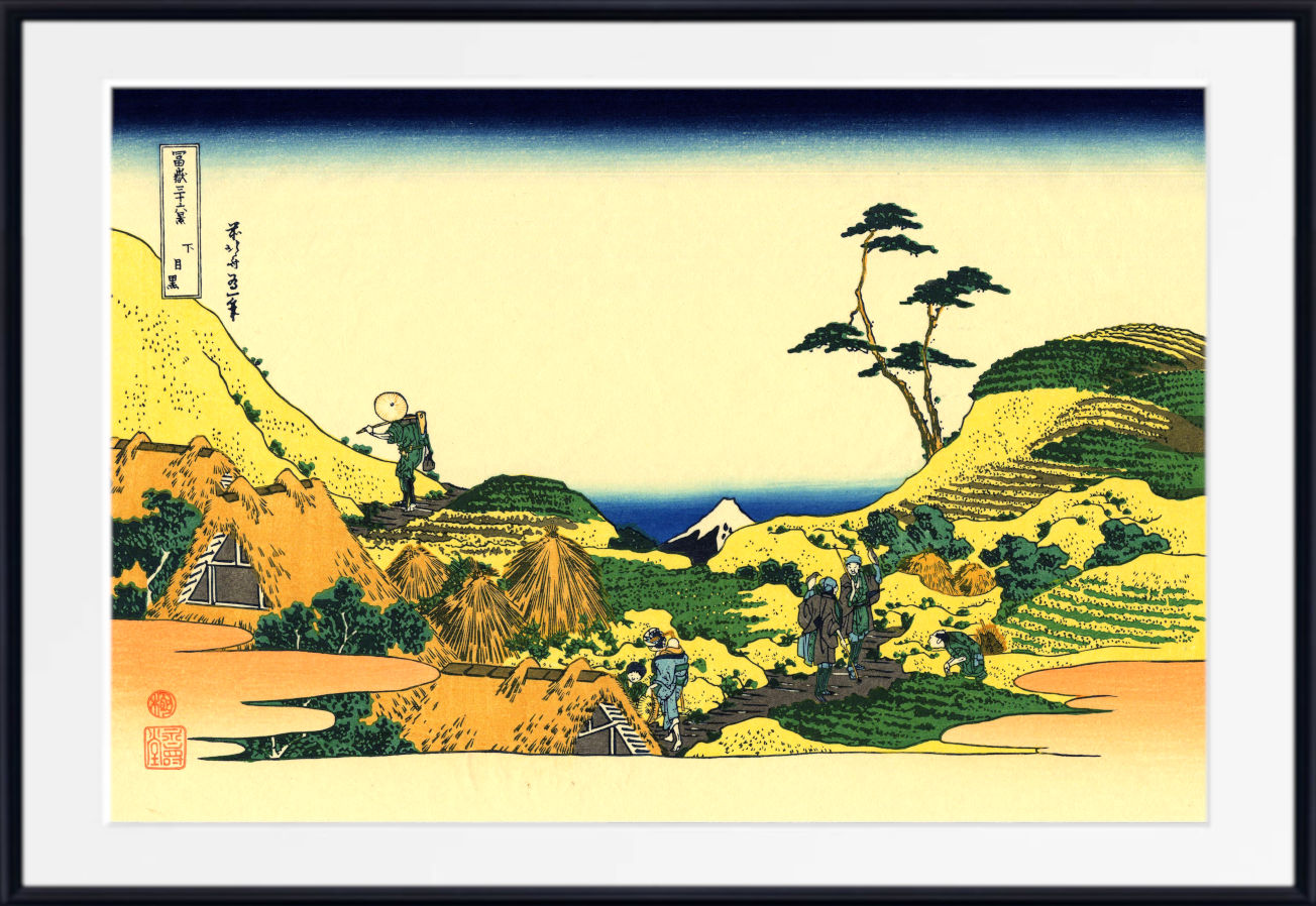 A framed Japanese-style landscape print with a wide white mat and black frame. The artwork shows rolling yellow-green hills, a lone tree, small figures, and a blue mountain or sea in the distance under a pale sky.