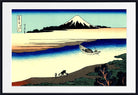 A framed Japanese-style art print depicting a snowy mountain, blue water, a small boat, and figures on a shoreline, shown against a white mat and black frame.