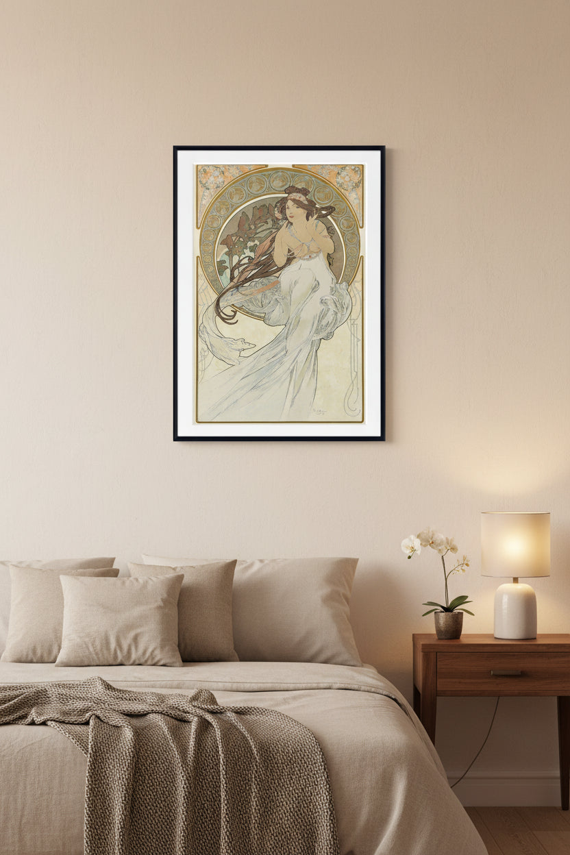 A framed Art Nouveau style art print featuring a woman in a flowing white gown with long dark hair, surrounded by ornate gold and beige decorative borders on a cream background.