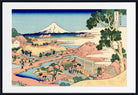 A framed Japanese ukiyo-e woodblock print depicting Mount Fuji, a river scene with figures, boats, and a large tree in the foreground, shown against a white mat and black frame.