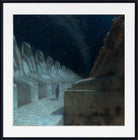 A framed art print depicting a night scene with a lone figure walking between large seated statues under a starry sky, shown with a white mat and black frame.