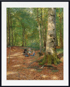 A framed art print depicting a serene forest scene with tall trees, a leaf-covered ground, and a few small figures in a meadow. The print is presented with a wide white mat and a simple black frame.