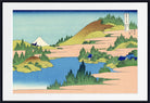 A framed Japanese-style landscape print showing blue water, sandy banks, green trees, and a white mountain under a pale blue sky, with a black frame and white mat.