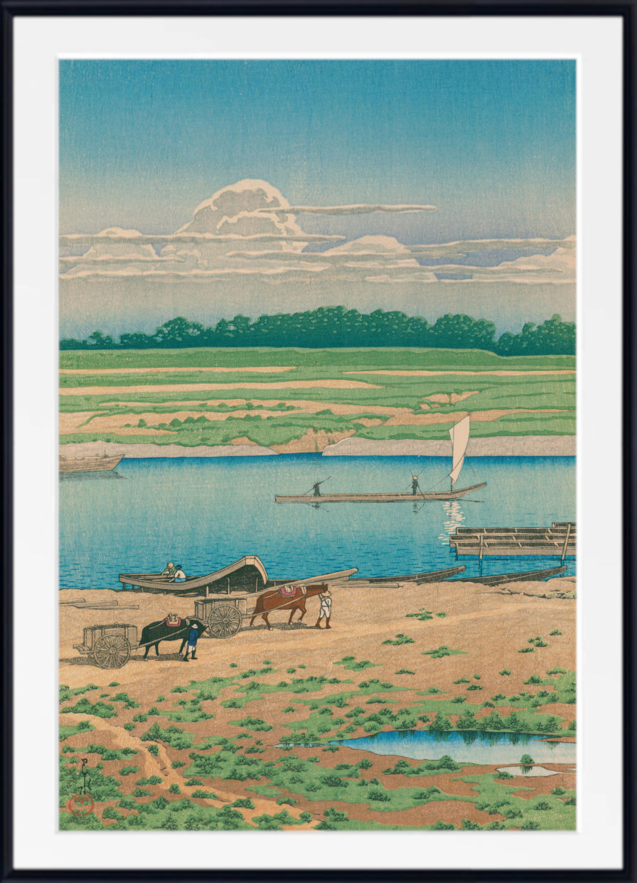 A framed art print depicting a serene landscape with a river, boats, a sailboat, and a horse-drawn cart on a sandy shore under a blue sky with clouds.