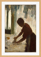 Edgar Degas Print, A Woman Ironing (1873) in a light oak frame