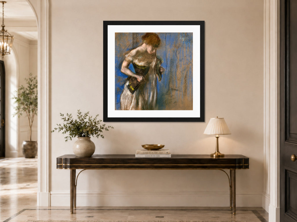 Edgar Degas Print, Femme mettant son corset (circa 1883) displayed above a console table