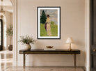 Edward Cucuel Print, After the rain, early (1910) displayed above a console table