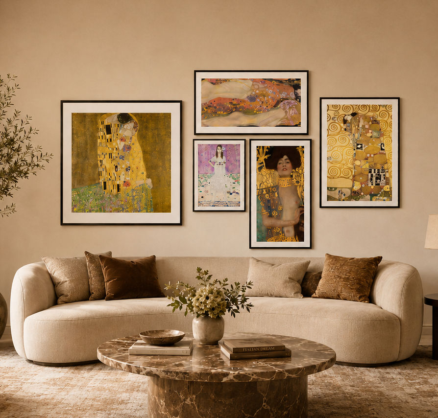 A styled living room with a curved cream sofa, a round marble coffee table, and a beige wall displaying five Gustav Klimt framed art prints in a gallery wall arrangement.