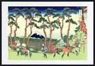 A framed Japanese ukiyo-e woodblock print depicting Mount Fuji, tall pine trees, and several figures on horseback and on foot in a landscape scene.