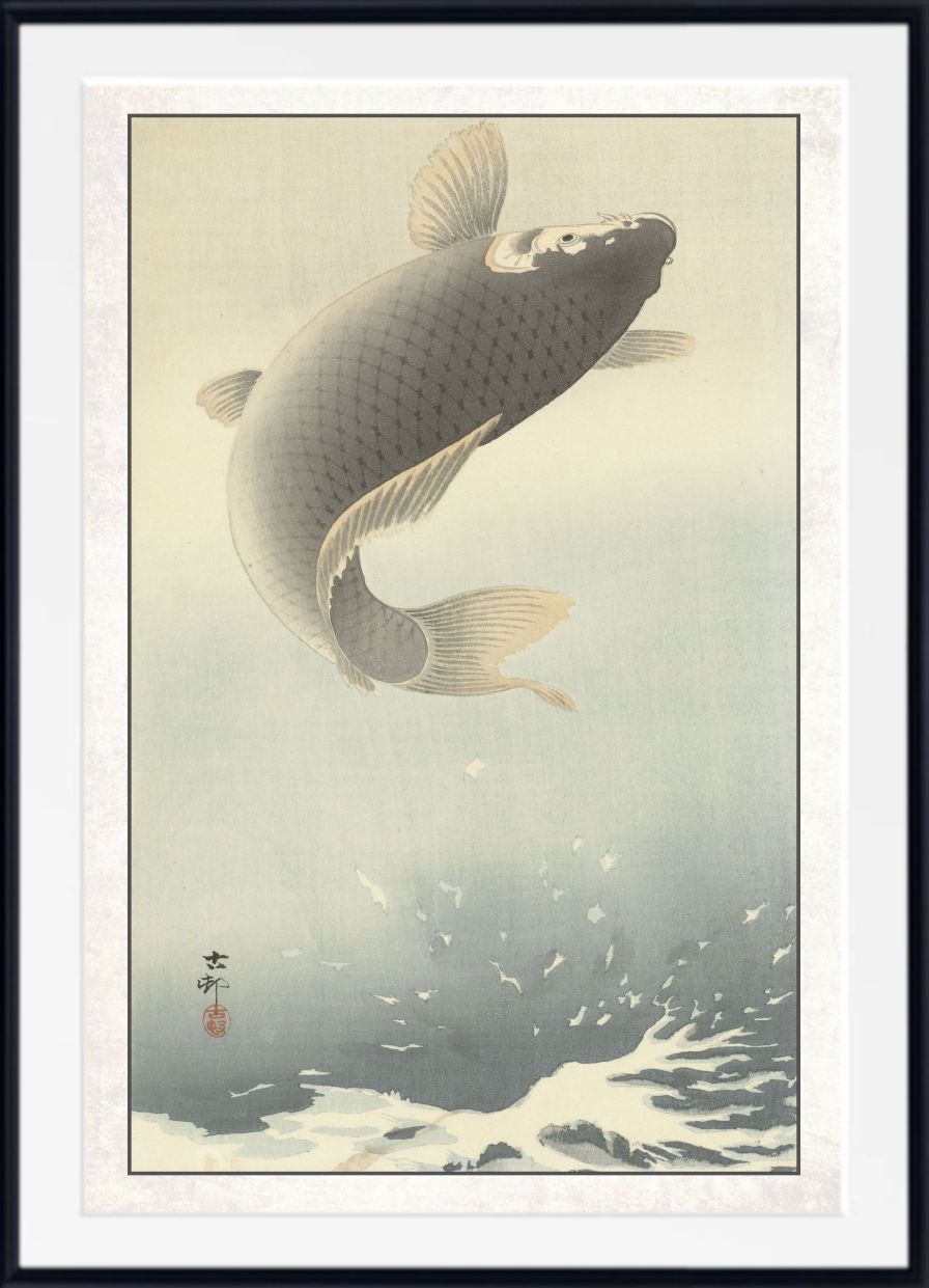 A framed Japanese-style art print depicting a large koi fish leaping through pale water, with a white mat and black frame around the artwork.