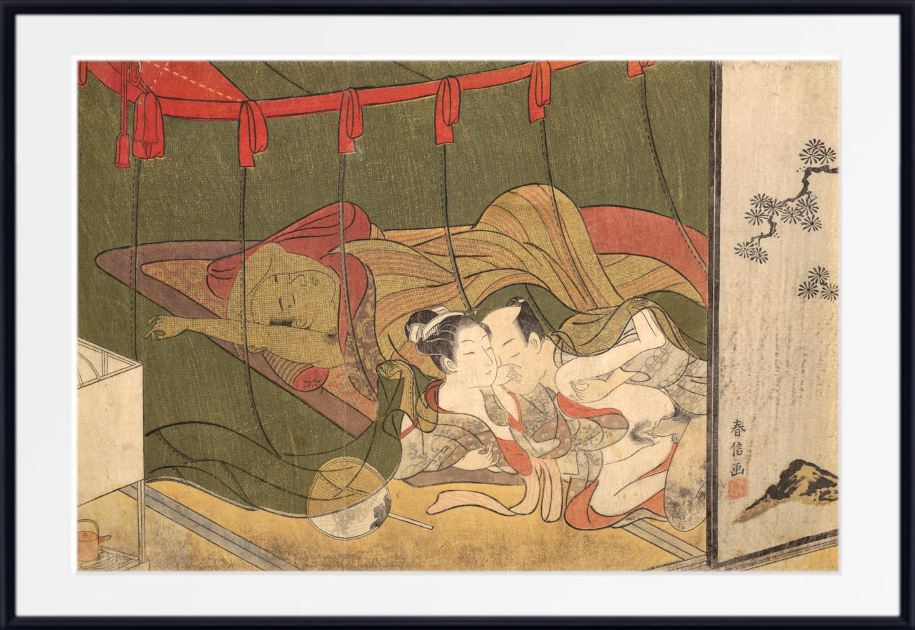 A framed Japanese ukiyo-e woodblock print depicting an intimate scene between two figures, with a white mat border and black frame around it.