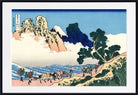 A framed Japanese-style art print showing a mountain landscape with a snowy peak, blue sky, waves, and a group of people and horses along a path. The print is presented with a white mat and a black frame.